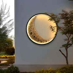 a circular mirror with an image of the moon in it