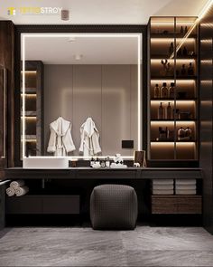 a bathroom with a large mirror and two robes hanging on the wall next to it