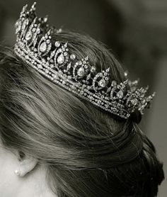 a woman wearing a tiara in black and white