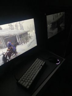 two computer monitors with people playing video games in the dark, one is turned on