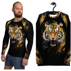 Don't let sunburn, wind, sand, or other elements ruin your day! This Men's Smooth & Versatile Rash Guard Activewear Shirt with a Unique Tiger Design will protect you while you have fun doing sports. It is slim-fitted with flat ergonomic seams, and a bit longer than your casual tee for extra comfort and protection. * 82% polyester, 18% spandex * Very soft four-way stretch fabric that stretches and recovers on the cross and lengthwise grains * UPF 50+ * Comfortable longer body and sleeves * Flat s Casual Long Sleeve Tops For Water Sports, Long Sleeve Sports Shirt For Summer, Long Sleeve Shirt For Summer Sports, Casual Crew Neck Rash Guard For Water Sports, Moisture-wicking Crew Neck Top For Water Sports, Graphic Print Crew Neck Top For Water Sports, Crew Neck Top With Graphic Print For Water Sports, Yellow Sports Shirt For Summer, Yellow Summer Sports Shirt