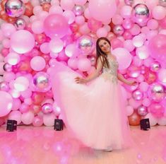 a woman is standing in front of balloons