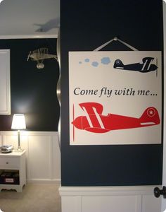 there is a sign that says come fly with me on the wall in this room