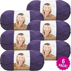 six skeins of yarn in purple, each with a smiling woman's face