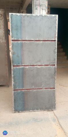 a large metal box sitting on top of a cement floor in a warehouse or building