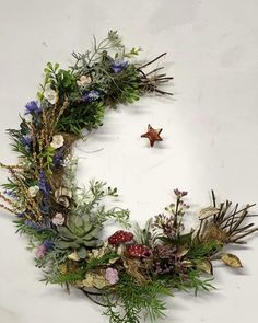 a wreath made out of branches and flowers