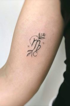 a woman's arm with a small tattoo on the left side of her arm