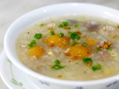 a white bowl filled with soup on top of a table