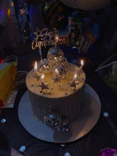 a birthday cake with lit candles and decorations