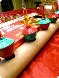 there are many cups and saucers on the long table top, all lined up