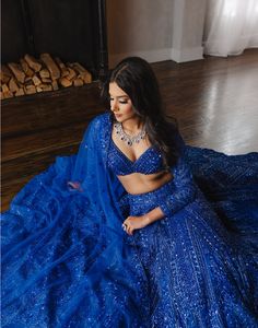 Featuring Fida, a beautiful electric blue hand-embroidered lehenga with a full sleeved blouse and matching dupatta. DELIVERY TIMEPlease allow 1 week for your order to be dispatched. FABRIC DETAILSNet Professional cleaning only. Fitted Blue Gown With Mirror Work, Blue Saree Gown With Intricate Embroidery, Elegant Blue Anarkali Set With Unstitched Blouse, Blue Anarkali Set For Reception With Sheer Dupatta, Blue Bollywood Gown For Designer Wear, Elegant Blue Choli With Dupatta, Bollywood Style Blue Choli With Mirror Work, Festive Blue Choli With Sheer Dupatta, Blue Bollywood Choli With Mirror Work