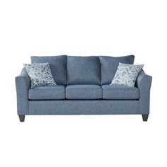 a blue couch with two pillows on it's back and one arm facing the camera