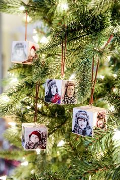 ornaments hanging from the branches of a christmas tree with pictures of people in them on them