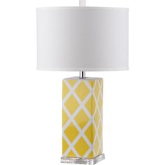 a yellow and white table lamp with a white shade on the top, in front of a white background