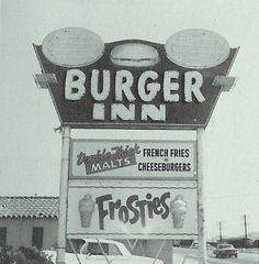 an old photo of a burger inn sign