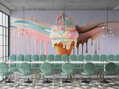 an ice cream sundae sits on top of a long table with mint green chairs