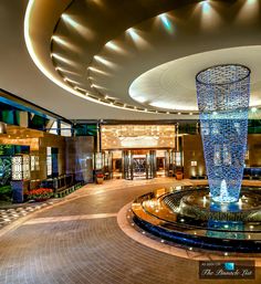 the inside of a hotel lobby with a fountain