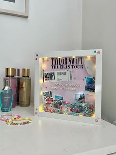 a vanity mirror sitting on top of a white counter next to bottles and other items