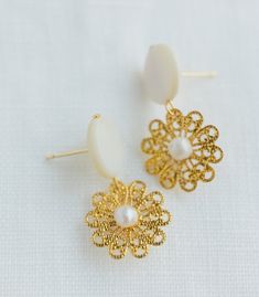 * Use discount FOURITEMS to get 10% off when you purchase 4 items or more across all our products (jewelry, ceremony items, etc) * Designed and handcrafted in the Philippines * Gold-plated brass stud and flower, along with backings that consists of secure lock backs * Made with mother of pearl and South Sea pearls, locally sourced from Minglanilla & Cebu City to support traditional crafts * 1.5inches in length and 0.5inch in width, lightweight to wear all day * Materials are locally and ethicall Handmade Brass Pearl Earrings For Wedding, Handmade Brass Bridal Earrings, Handmade Brass Bridal Earrings Elegant Style, Handmade Elegant Brass Bridal Earrings, Elegant Handmade Brass Bridal Earrings, Elegant Round Brass Bridal Earrings, Handmade Round Flower Earrings For Wedding, Elegant Brass Flower Earrings Nickel Free, Elegant Brass Flower Earrings As Gift