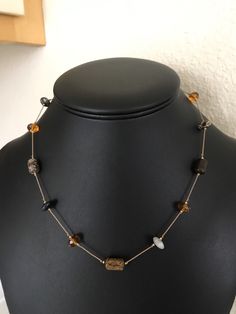 This variegated agate and jasper stone and faceted golden amber glass bead necklace has flat disc and round barrel shaped beads strung on silk. The necklace has a 14 K GF clasp. The large beads are 8mm wide. The necklace is 18 inches long. This is well made and elegant. I specialize in finding fun wearable jewelry. Please browse my shop for more options. I box jewelry sales ready to be given as gifts. Elegant Brown Czech Glass Necklaces, Spiritual Brown Necklace With Faceted Beads, Spiritual Brown Necklace With Spacer Beads, Brown Faceted Beads Necklace As Gift, Brown Beaded Necklace With Faceted Beads For Gifts, Brown Faceted Beads Necklace For Gift, Brown Czech Glass Gemstone Beaded Necklaces, Brown Czech Glass Beaded Necklaces With Gemstone Beads, Brown Beaded Necklace With Czech Glass And Gemstone Beads