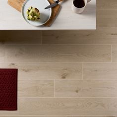 a white table topped with a plate of food next to a cup of coffee and a knife