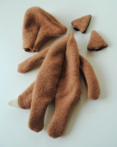 several pieces of brown teddy bear laying on top of each other