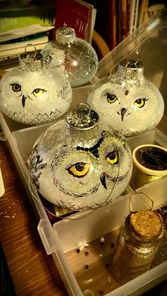 three glass owl ornaments sitting on top of a table