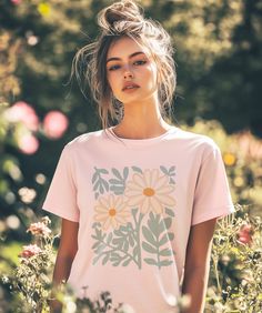 Step into a world where nature's beauty meets timeless charm with our Daisy Flowers T-Shirt. Inspired by the delicate dance of daisies in a sunlit meadow, this enchanting tee embodies the essence of the cottagecore aesthetic. The design seamlessly blends bohemian vibes with minimalist floral art, making it a versatile piece for any occasion. Whether you're a nature lover, a plant enthusiast, or someone who embraces the serene and whimsical cottagecore lifestyle, this t-shirt is your perfect comp Cottagecore Lifestyle, Whimsical Cottagecore, Minimalist Flower, Flower Art Print, Bohemian Vibes, Minimalist Flowers, Effortless Beauty, Art Making, Plant Lover Gift