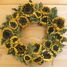 a sunflower wreath on a wooden wall