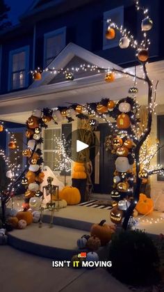 a house decorated for halloween with pumpkins and lights