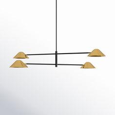 three brass colored lights hanging from a black metal bar with four gold colored lamps on each end