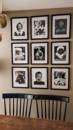 black and white photographs hang on the wall above a wooden dining room table with chairs