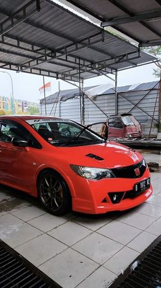 a red car is parked in a garage