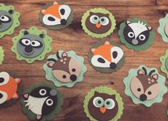 cupcakes decorated with animal faces on a wooden table