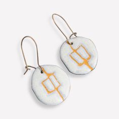 Imagine wearing these beautiful pebble shaped enamel dangle earrings -- so distinctive yet casual enough to wear everyday!  These yellow and white art jewellery earrings have high quality hand formed brass ear wires that clasp so you never have to worry about losing them! They are light weight to wear and have a raised texture due to the sgraffito technique I use to make them.   What is enamel?   Enamel is made by fusing multiple layers of glass to a prepared metal at a very high heat.  Each ear Pierced Dangle Earrings In Enamel, Artistic White Drop Earrings, White Artisan Drop Earrings, Artistic Enamel Jewelry With Matching Earrings, Artisan White Drop Earrings, Unique Hand Painted White Earrings, Artistic White Round Earrings, Unique White Pierced Earrings, Artisan White Enamel Jewelry