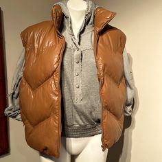 Be Prepared For Between Seasons In This Super Cute Faux Leather Zip Front Puffer Vest. Funnel Neck. 2 Side Zipper Pockets. Lined. Wipe Clean With A Damp Cloth. Brown Puffer Outerwear For Fall, Brown Winter Outerwear For Layering, Trendy Brown Puffer Outerwear, Leather Puffer Outerwear For Fall, Casual Brown Outerwear For Layering, Brown Puffer Outerwear For Spring, Brown Outerwear For Spring Layering, Brown Spring Outerwear For Layering, Oversized Brown Leather Outerwear