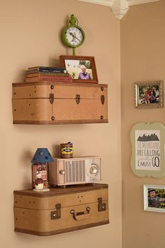 two suitcases are stacked on top of each other in front of a wall clock