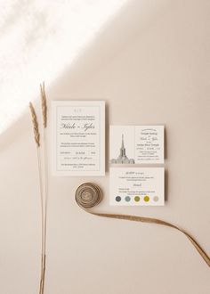 the wedding stationery is laid out on top of the table