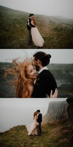 a couple embracing each other while standing on top of a hill next to the ocean