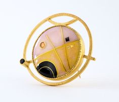 This modern convertible brooch pendant has a 24K gold cloisonne vitreous enamel on silver jewel in a geometric design with deep black, petal pink and warm yellow set into gold vermeil over sterling silver with faceted black spinel, enamel measures 1" diameter, overall 1.5" *please use my contact page to request additional details Unique Yellow Gold Enamel Brooch, Modern Gold Collectible Jewelry, Modern Gold Jewelry For Collectors, Luxury Gold Enamel Pin Gift, Luxury Gold Enamel Pin As Gift, Luxury Gold Enamel Pin For Gift, Modernist Gold Brooches For Gifts, Unique Handmade Gold Enamel Pin, Contemporary Formal Brooch Jewelry