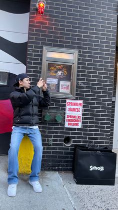 a man taking a photo of himself in front of a restaurant