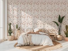 a bedroom with pink and white wallpaper, potted plants and a bed in the corner