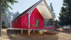 a small red house sitting in the middle of a forest