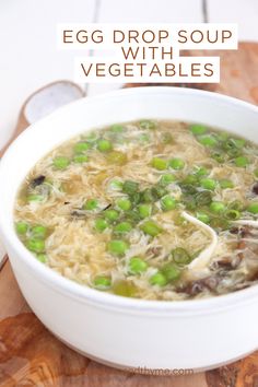 egg drop soup with vegetables in a white bowl