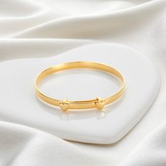 A keepsake token of love, golden sparkles and well wishes. The best-selling My First Diamond Baptism Baby Bangle has been updated with an 18ct gold vermeil touch. A beautiful design, it is the perfect baby bangle to give as a unique goddaughter gift or newborn jewelry. Set with two hearts and a genuine 1pt diamond this timeless, adjustable Baptism baby bangle will expand over the widest part of her hand, lasting her until around the age of three. It can then be treasured as a memorable keepsake Baby Jewelry Gold, Baby Jewellery, Toddler Jewelry, Goddaughter Gifts, Baby Bangles, Fairy Charms, Bangles Design, Baby Necessities