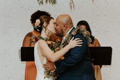 a bride and groom kissing in front of the choir at their wedding ceremony on stage