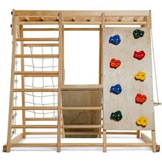 a wooden climbing wall with colorful rocks and ladders on the side, against a white background