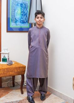 Hello,  Formal Style Kameez Shalwar for Kids ,  Easy Iron ,Soft Fall Finish Yarn Dyed Fabric with Geometric Design Rich Ari Embroidery on the Collar and the Front Placket. Available in sizes, 18, 22, 24, 26, 28, 30. Purple Self Design Kurta For Eid, Navratri Jamawar Sets With Naqshi Details, Shantoon Kurta With Dabka For Navratri, Navratri Shantoon Kurta With Dabka, Traditional Shantoon Churidar For Eid, Eid Traditional Wear With Dabka On Shantoon, Eid Shantoon Sets With Pallu, Traditional Purple Sets With Dabka, Eid Traditional Wear With Dabka On Jamawar Fabric