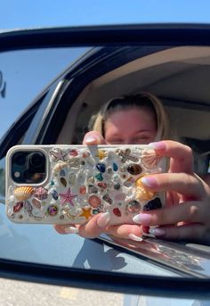 a woman taking a selfie in her car mirror