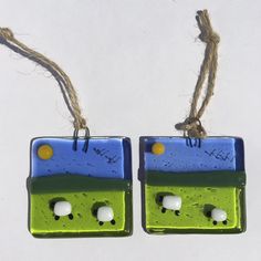 two green and blue ceramic pieces hanging from twine